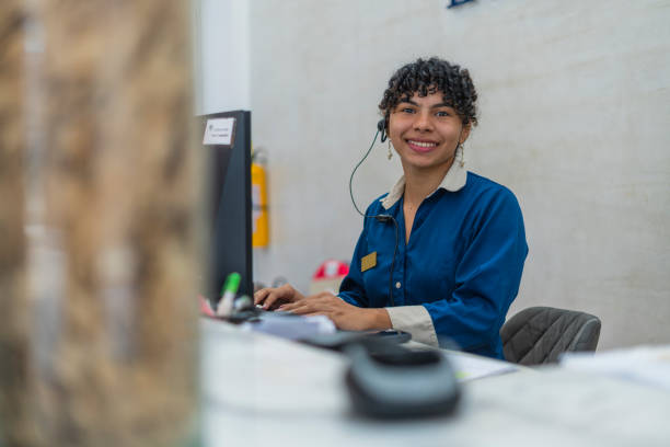 istock young woman receptionist in hotel smiling looking at camera 2163683740