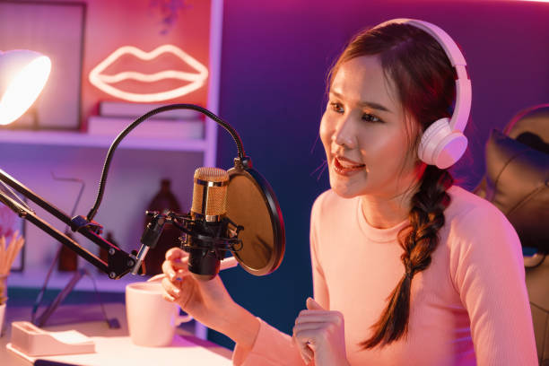 istock Smiling creative young beautiful Asian influencer talking in channel. Stratagem. 2163684691