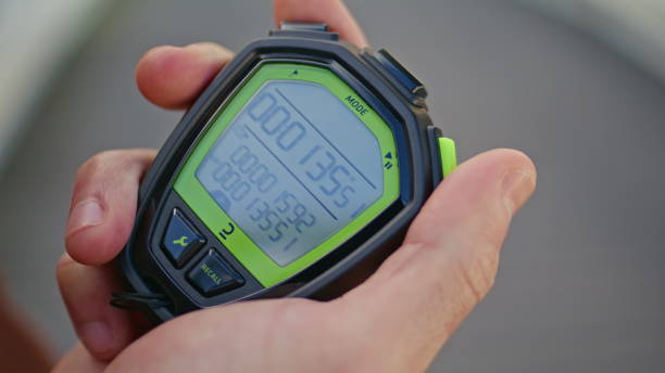 istock Hand pressing sport timer on race competition. Closeup man holding stopwatch 2163685420