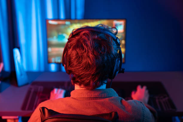istock Gaming streamer team playing battle game shooting at back side image. Gusher. 2163685886