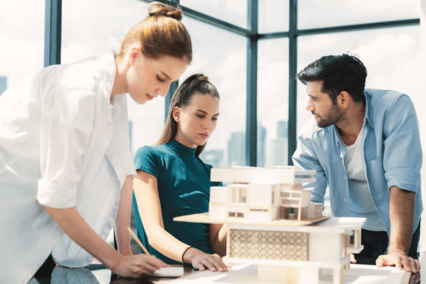 istock Professional architect team working together to design house model. Tracery. 2163687712