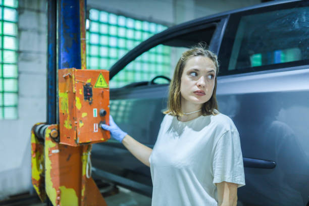 female auto mechanic in car service workshop