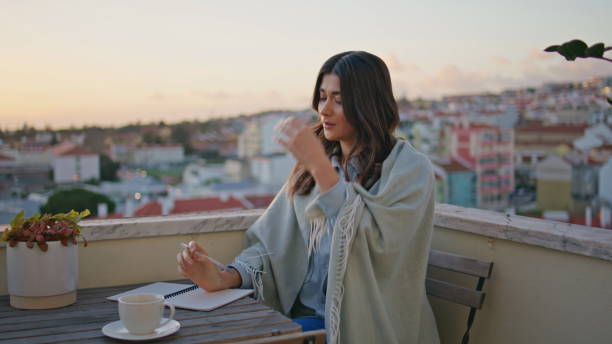 istock Dreamy woman writing diary resting sunset terrace closeup. Author creating book 2163691401