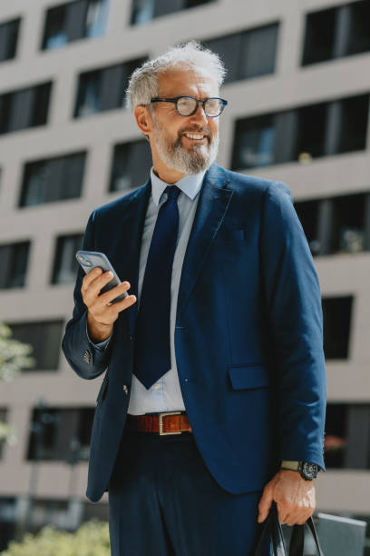 istock Confident Businessman Outdoors Using Smartphone in Urban Setting 2163692142