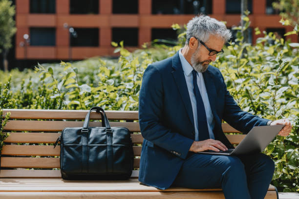 istock Businessman Working On Laptop Outdoors In Park 2163692148