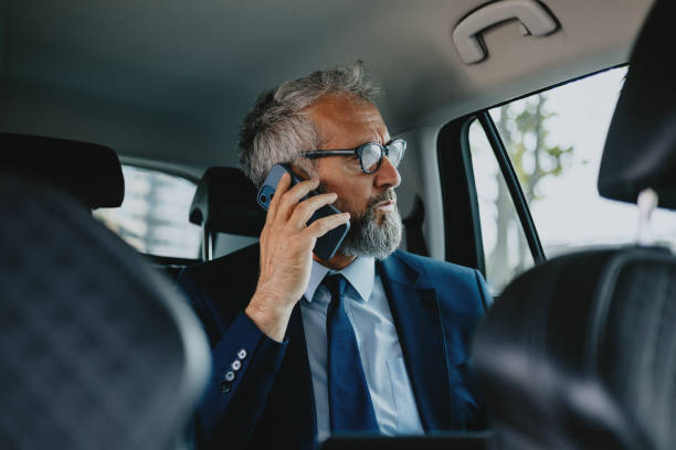 istock Businessman Talking on Phone in Car During Commute 2163692172