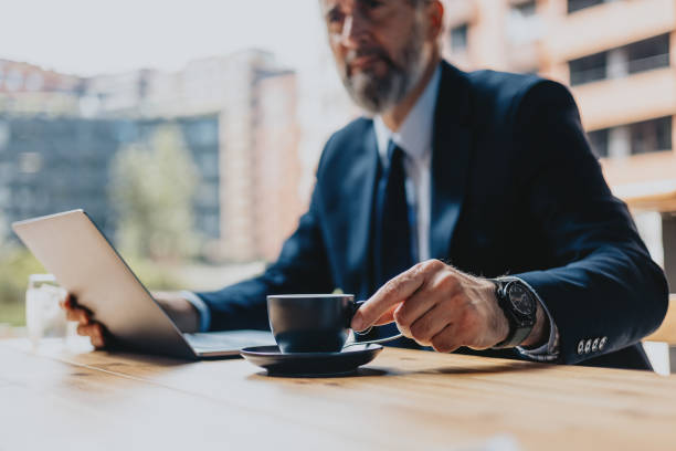 Businessman Working Outdoors with Laptop and Coffee