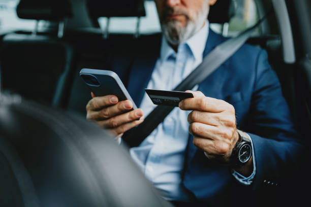 Businessman Conducting Online Payment Using Smartphone and Credit Card