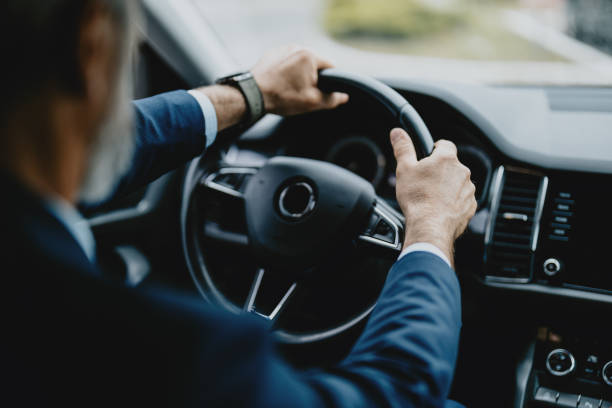 Businessman Driving Car, Focused on Steering Wheel