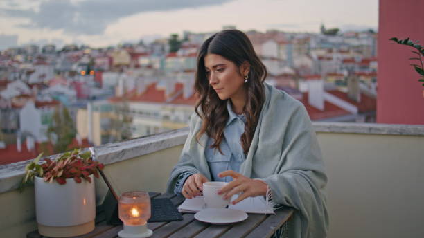istock Serious freelancer working sunset cityscape balcony closeup. Woman drinking 2163693122