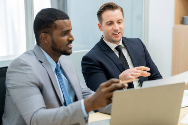 istock African male leader explain strategy while show solution to manager. Ornamented. 2163693290