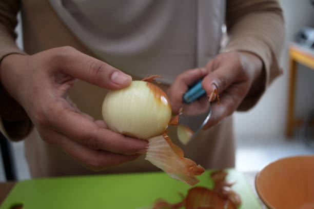 istock Asian muslim woman peeling onion 2163695668