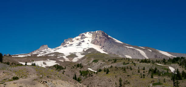 Summit of Mt Hood (South Side). Crater Rock can be seen in the center of photo near the peak. Palmer Chair Lift at Timberline Ski Resort can be seen on the left side of photo. Taken beautiful blue sky July day.