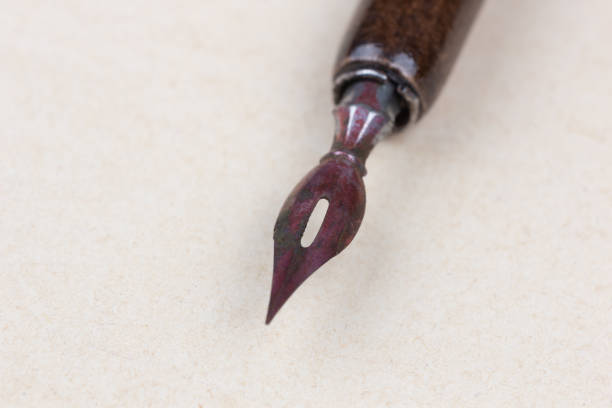 Fountain pen on an antique textured paper background.