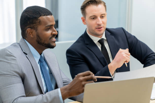istock African male leader explain strategy while show solution to manager. Ornamented. 2163698191