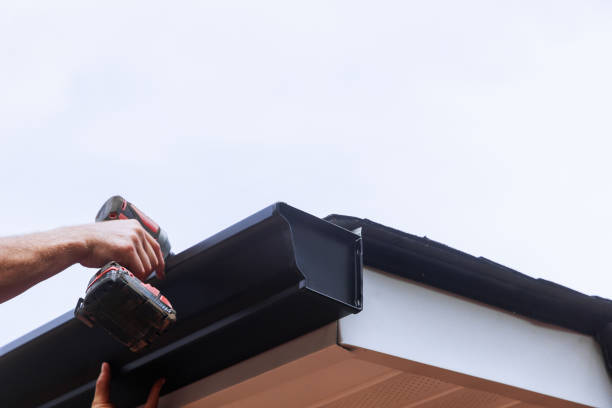 istock Worker installing rain gutter on roof is mounting a downpipe 2163700015
