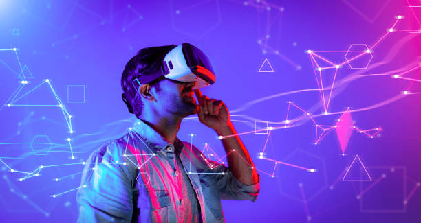 istock Smart caucasian man wearing VR glasses while standing at neon light. Deviation. 2163702626