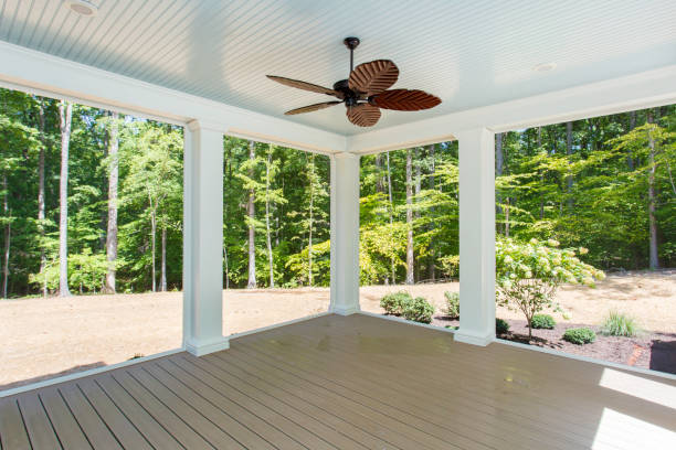 istock Open Patio With Wooden Deck And Overhead Fan Facing Greenery 2163702956