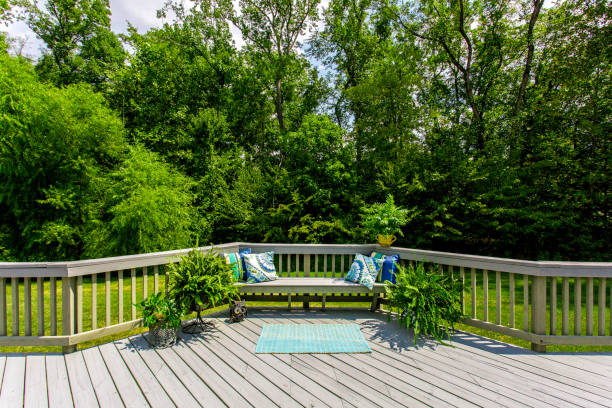 istock Panoramic Wooden Deck With Cushions Surrounded By Green Landscape 2163702971