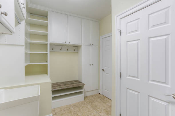 istock Organized Mudroom With White Built-In Cabinets, Bench, And Hooks On Tiled Floor. 2163703102