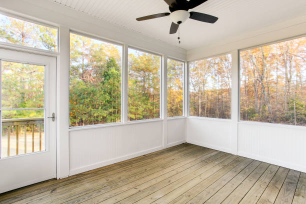 istock Spacious Covered Porch With A Fan Overlooking A Lush Garden And Greenery. 2163703132