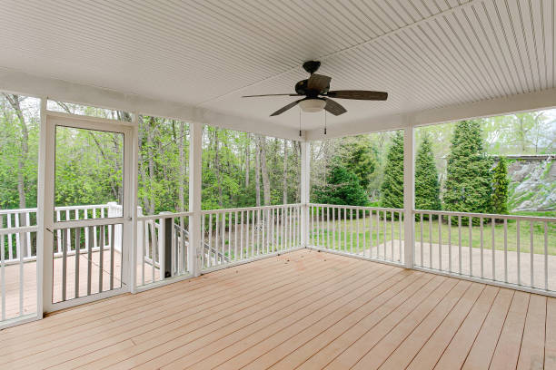 istock Enclosed Patio With White Railings And Ceiling Fan Overlooking Green Backyard. 2163703201