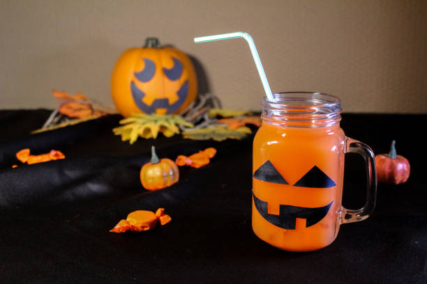 istock Orange cocktail mocktail juice in pumpkin mason jar for Halloween 2163705573