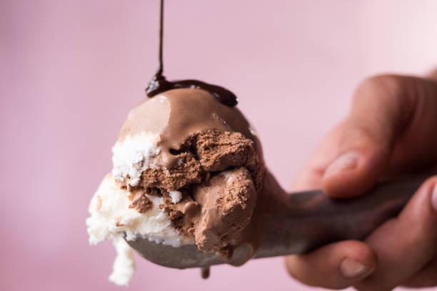 istock Hand holding an ice cream scoop with ice cream 2163708291