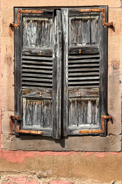 istock Weathered wooden window shutter creates interesting European still life scene 2163708345