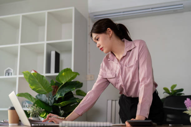 istock Professional Businesswoman Working in Modern Office with Laptop and Documents 2163711404