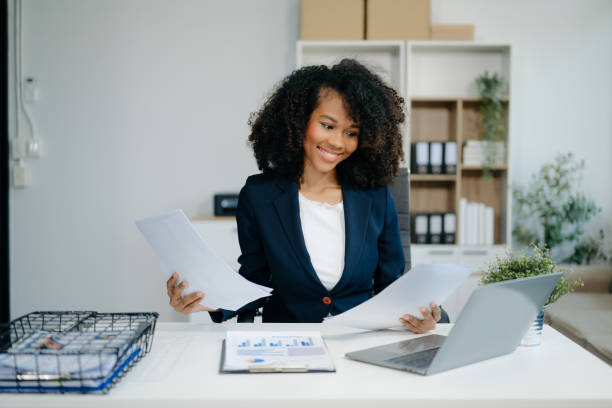 istock Confident woman with a smile standing holding notepad and tablet 2163711852