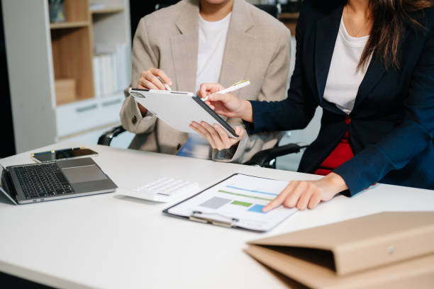 istock Businessman and team analyzing financial statement Finance task. with smart phone and laptop and  tablet. 2163711909