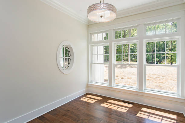 istock Bright Sunlit Empty Room With Large Windows And Glossy Wooden Floor 2163712247