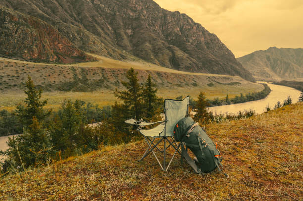 istock backpack and camping chair in the mountains 2163713549
