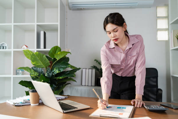 istock Professional Woman Working from Home Office with Laptop and Documents, Remote Work Concept 2163714427