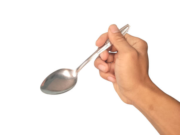 istock A man's hand is holding a spoon on a white background 2163715650
