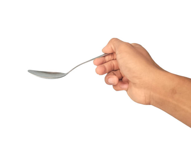 istock A man's hand is holding a spoon on a white background 2163715683