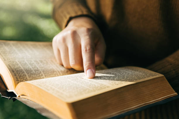 istock Young woman reading and study holy bible. 2163717374