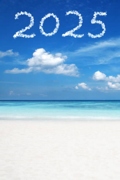 Word new year written on the sand of the beach. Beach and wave background.