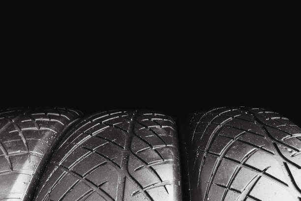 istock Car tire row isolated on black background with copy space for text , Old car tire with scratch 2163719295