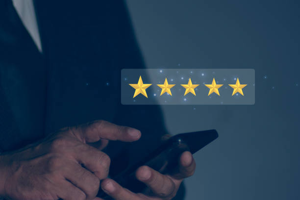 istock Businessman touching smartphone with pop up five star icon for feedback review satisfaction service, Customer service experience and business satisfaction survey. Concept of satisfaction rating. 2163720171
