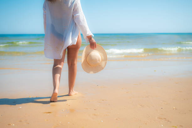 istock Unrecognizable Mature Woman Taking A Relaxing Walk On The Beach Barefoot. 2163722977