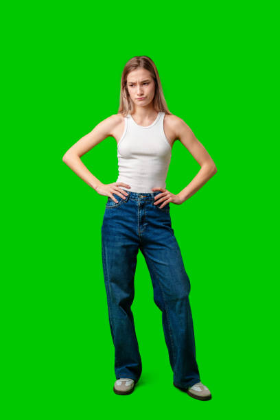 istock Young Woman Standing With Hands on Hips Against Green Screen 2163722993