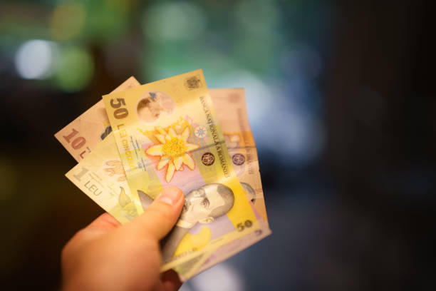 istock Hand holding banknotes. Romanian currency. 2163723382