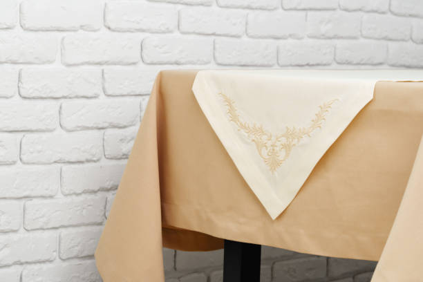 istock Beige Tablecloth on Wooden Table With White Brick Wall Background 2163724196