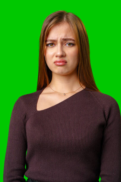 istock Young Woman With Sad Expression Against Green Screen 2163725083