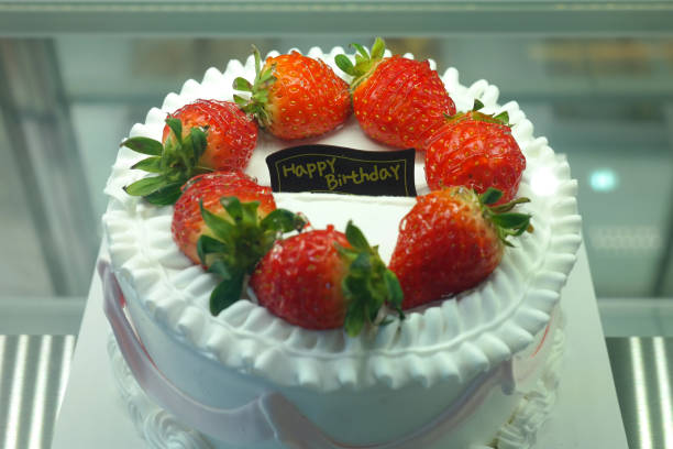 Strawberry cake with soft fluffy layers, topped with fresh strawberries and smooth cream, showcasing vibrant red fruit, delicate textures, and sweet inviting appearance in close-up detail
