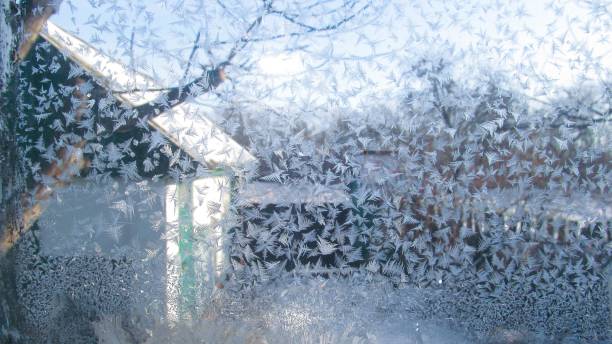 istock The ice crystals on the window. Frozen window. 2163728084