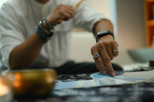 istock Close up view fortune teller randomly picking tarot card on a table covered with a mystical cloth 2163729316