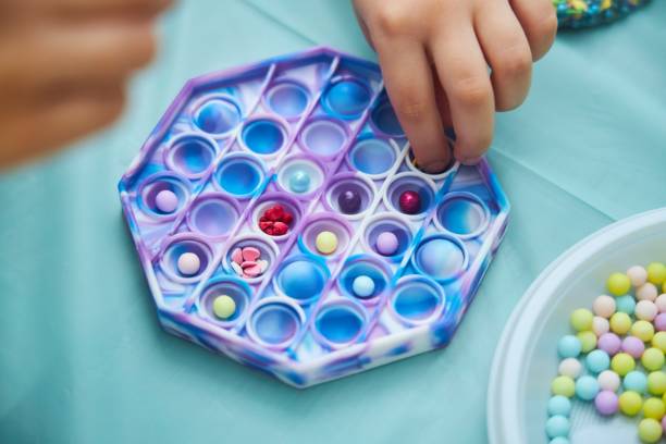 istock Cooking class for children. Making a delicious dessert using a silicone mold and lollipops of different shapes. 2163731351
